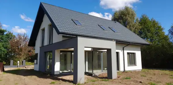 Nowoczesny dom 120 m² z szarym dachem i dużymi oknami. Zastanawiasz się, jaki koszt budowy domu 120 m²?